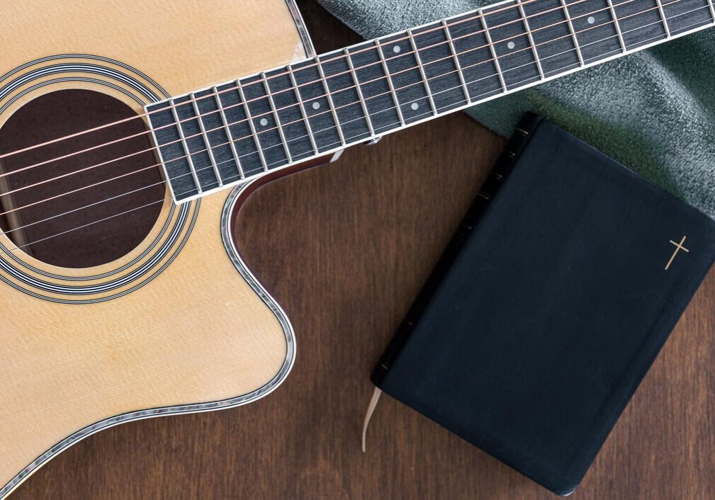 guitar-bible-book-wooden-background-top-view_169016-35117